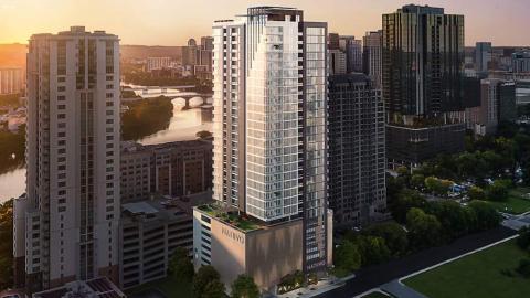 A rendering of a 33-story building consisting of a several-story parking podium with a glass and metal tower on top. There are tall buildings to the left and right of it, and between buildings is a view of a curving river.