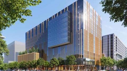 Rendering of a several-story, contemporary, coppery glass-covered office building attached to an equally high but less flashy apartment buiding with a park and some milling people around it.