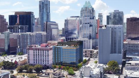Photo of midrange and tall buildings in downtown Austin with a rendering of a 13-story glass and tower with signage reading “Hotel Trinity” at the top inserted next to a Courtyard Marriott in the center.